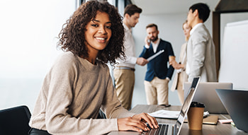 a corporate employee types on a laptop