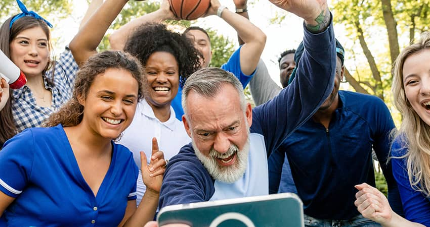 Sports fans cheer at a tailgate