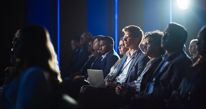 Conference attendees listen to a presentation